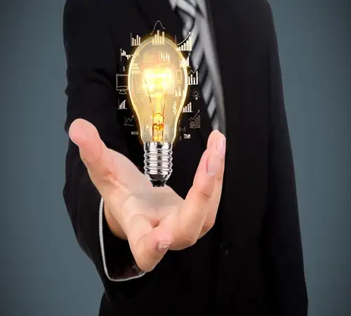 Professional holding a bulb ironically showing solution